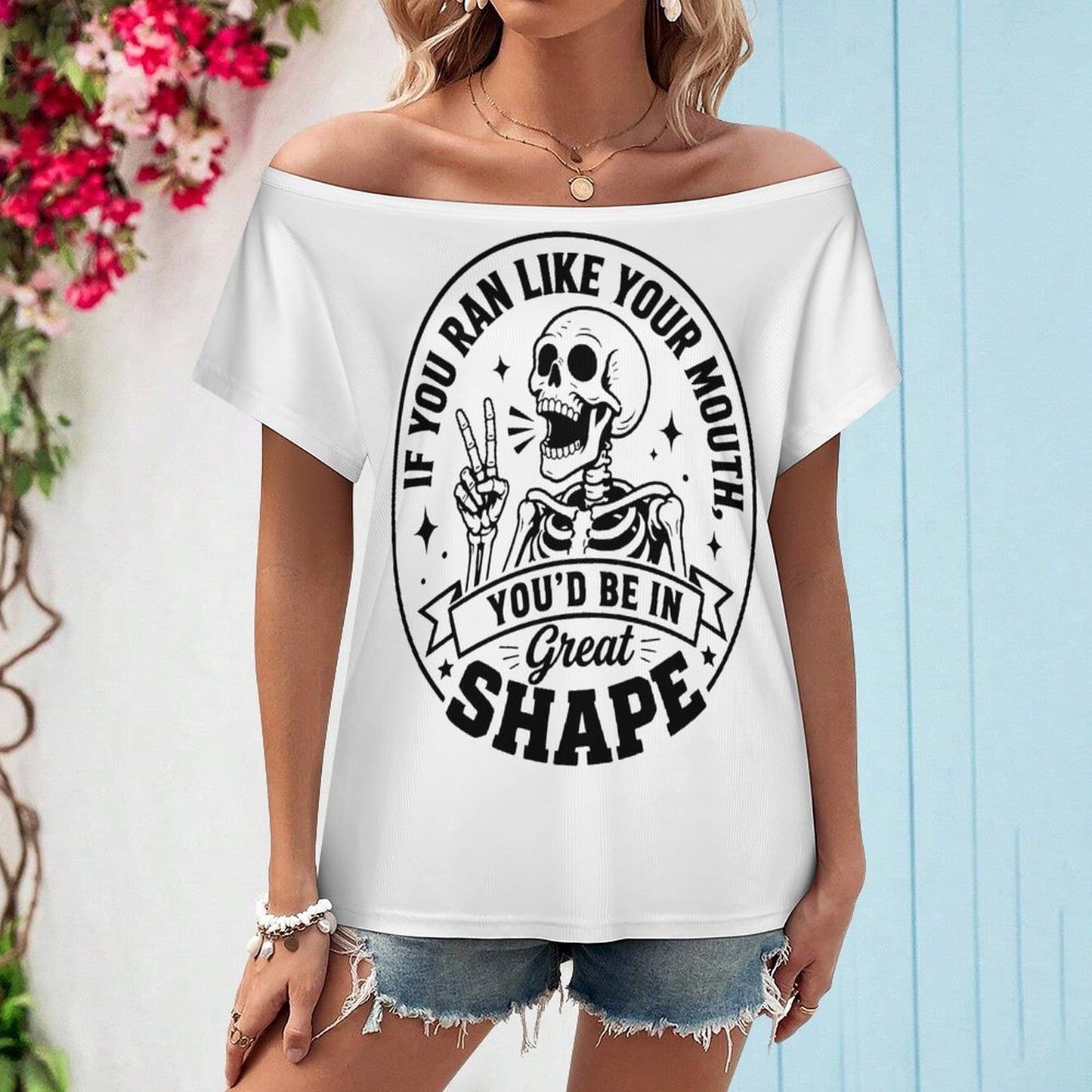 Close-up display of the snarky skeleton fitness graphic print on the front of a white fine-ribbed all-over print short-sleeve top.