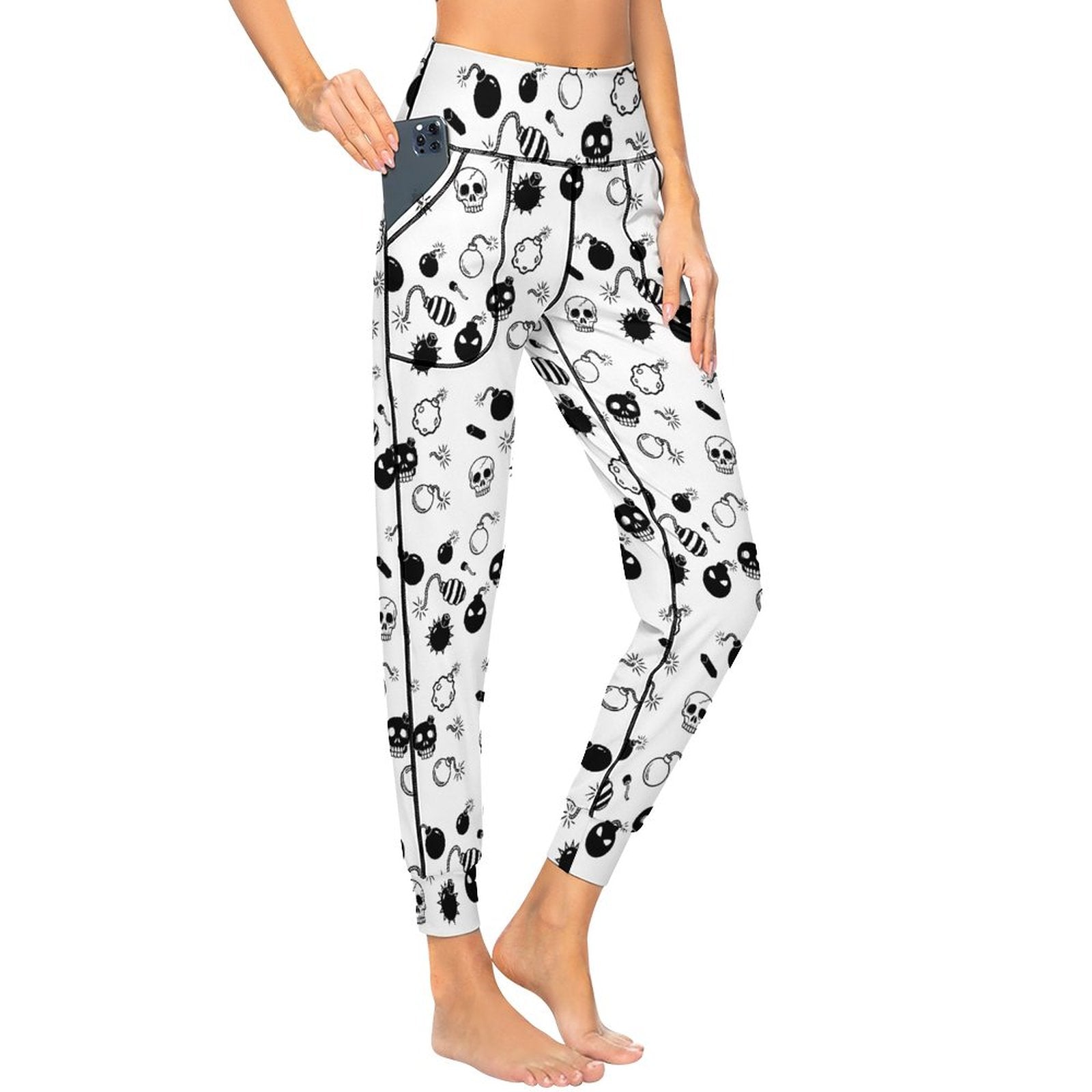 Front view of a model wearing high-waisted white yoga jogger pants featuring an all-over graphic print of retro bombs and skulls for a Y2K grunge streetwear look.