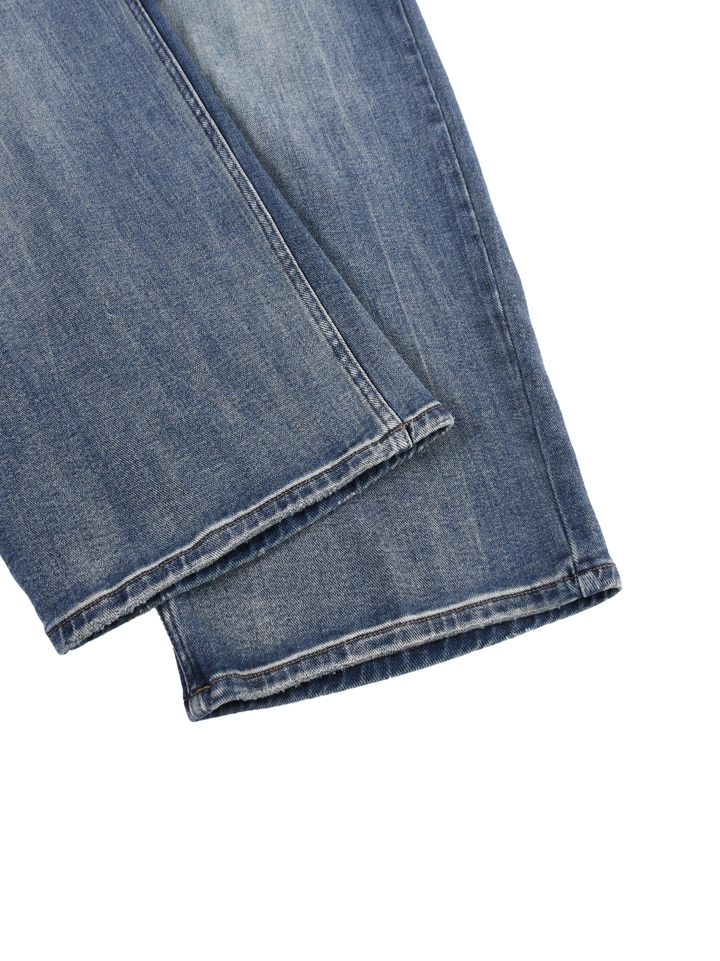 Close-up view of the front pocket layout and a folded wide-leg hemline on the blue ATEEZ sun-fade heavyweight denim jeans.