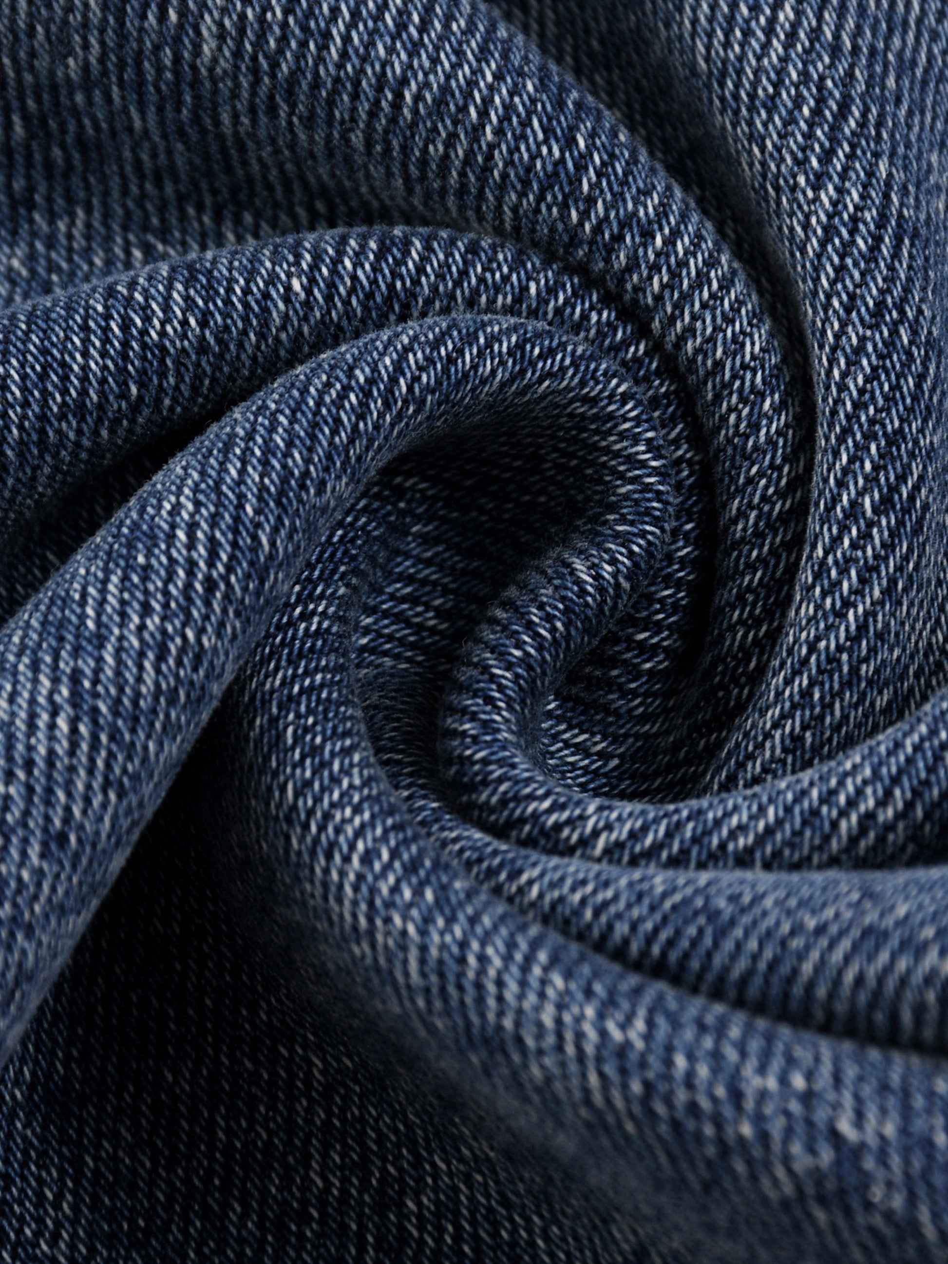 Close-up macro view of the swirled premium 16.0 oz heavyweight denim fabric texture on the BT21 King TATA jeans.