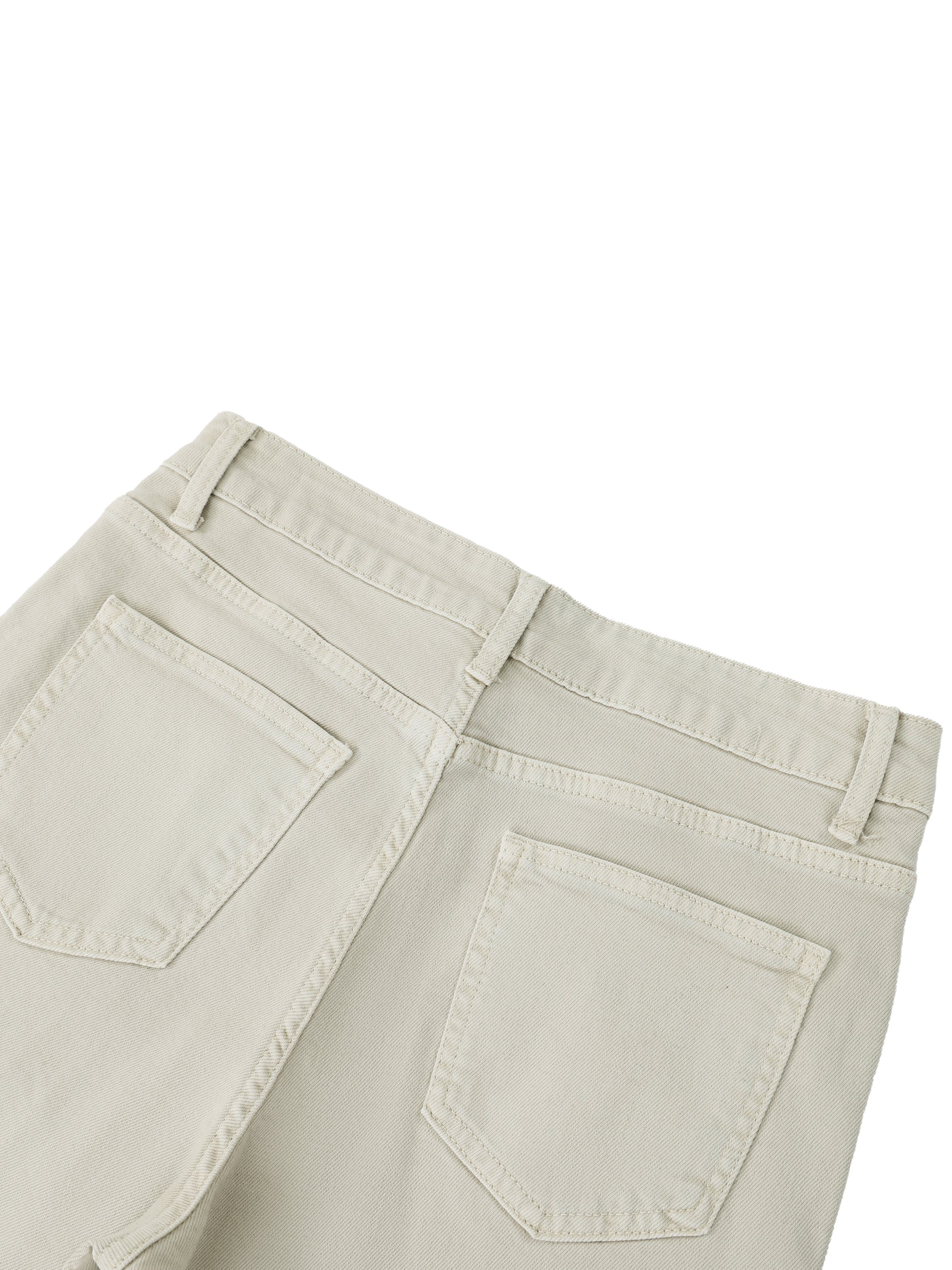 Close-up rear view of the waistband, classic back pockets, and heavy cotton texture on women's beige vintage wash flared leg jeans.