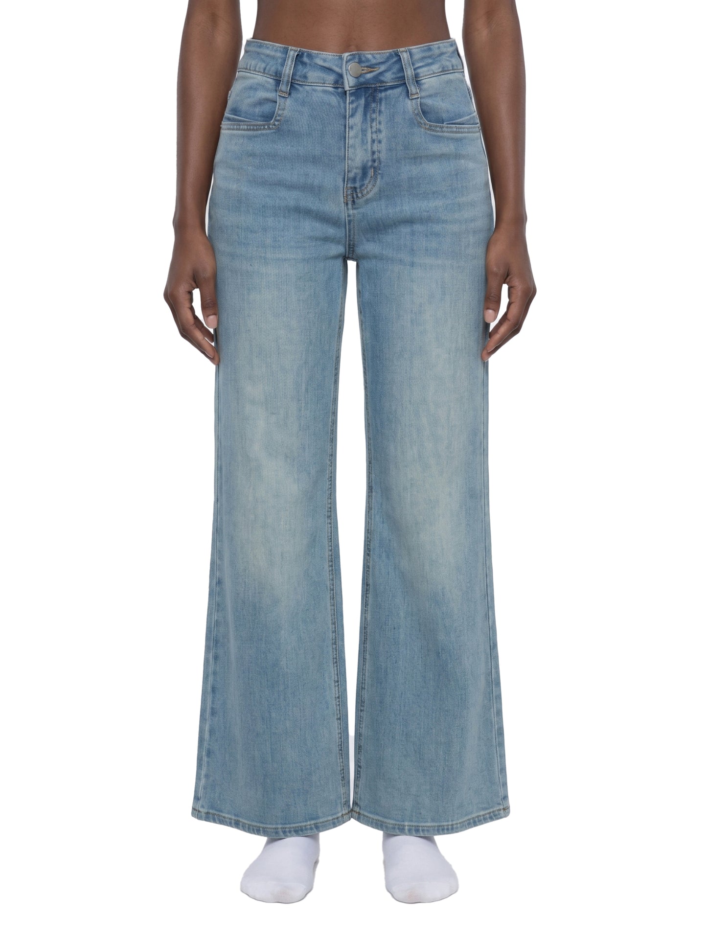 Frontview of a model wearing women's light blue flared jeans, showcasing the mid-waist fit, classic pocket placement, and straight wide-leg silhouette.