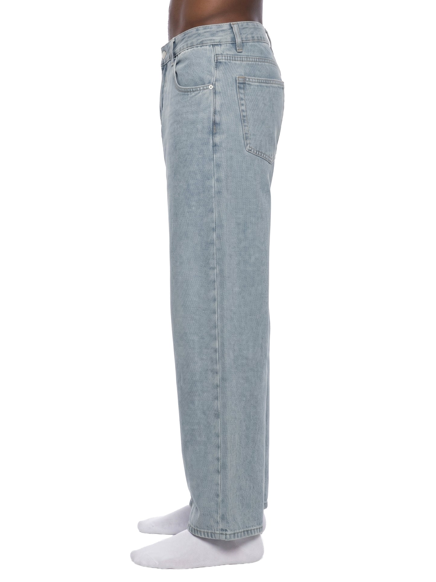 Side profile view of a model wearing unisex light gray vintage wash straight leg jeans, showcasing the loose fit and relaxed streetwear silhouette.