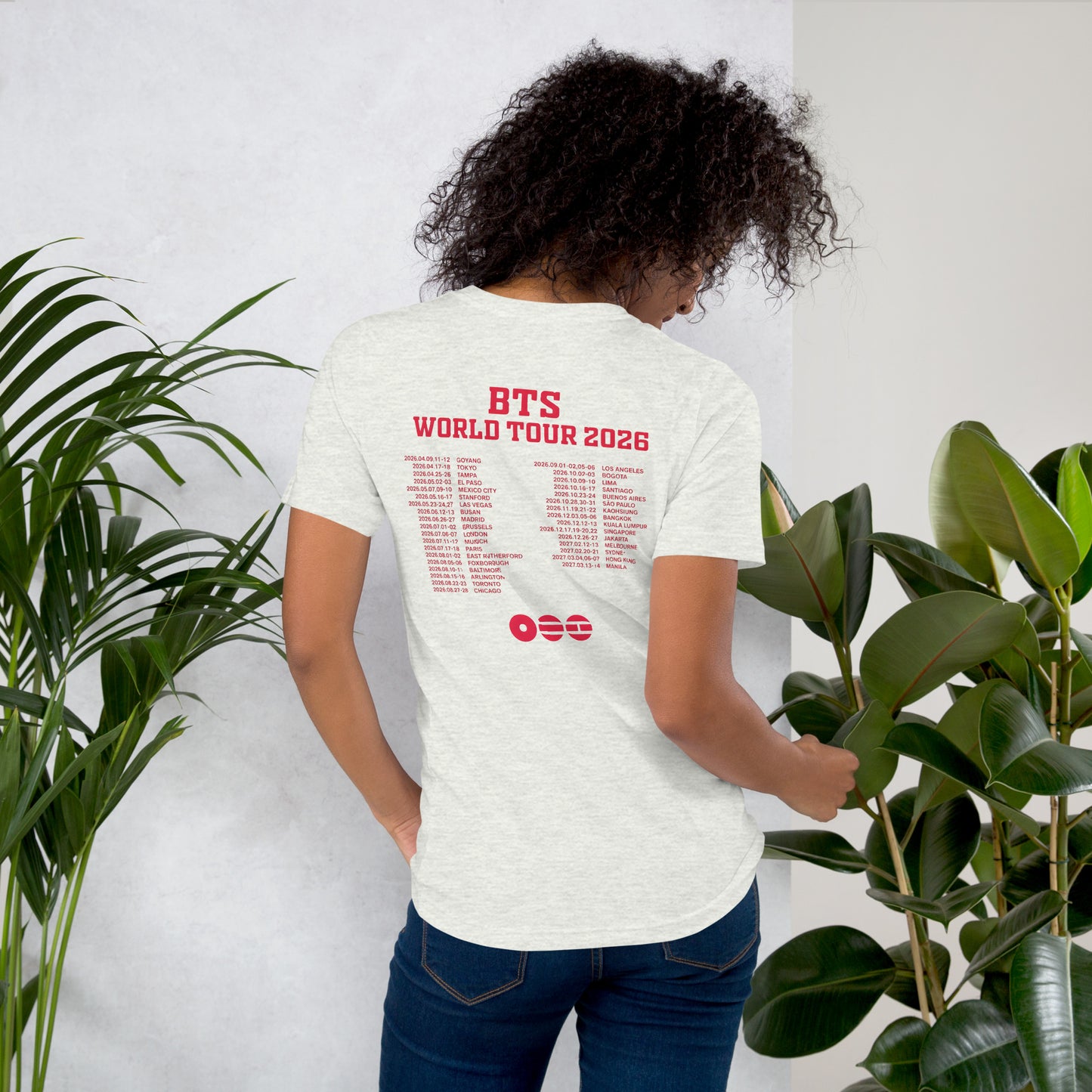 Back view of a model wearing the Ash gray BTS World Tour 2026 Hooligan t-shirt, showing red concert tour date graphics.